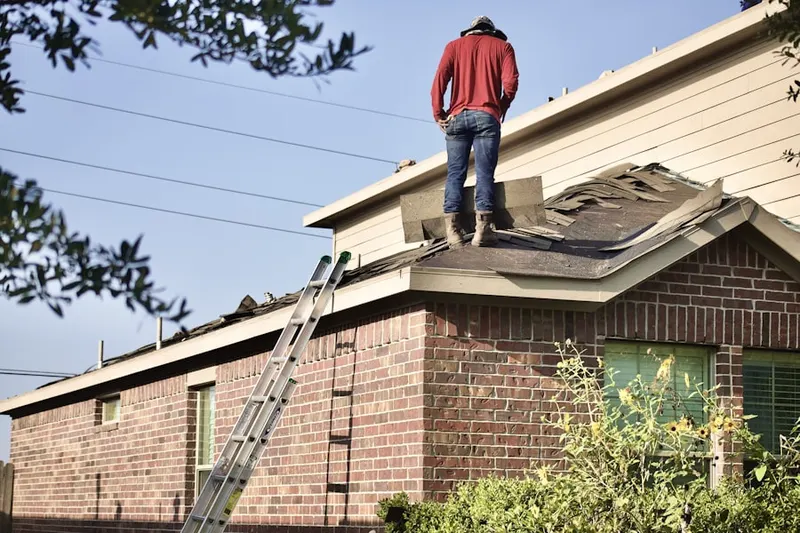 Professional roofer working on a residential roof in Wellfleet by the Sea